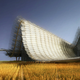 “Beneath the roof, the building’s ground plane is defined by a landscape of wheat… This natural landscape transitions seamlessly into an LED multimedia installation in the center that forms the centerpiece of the building’s exhibition program.